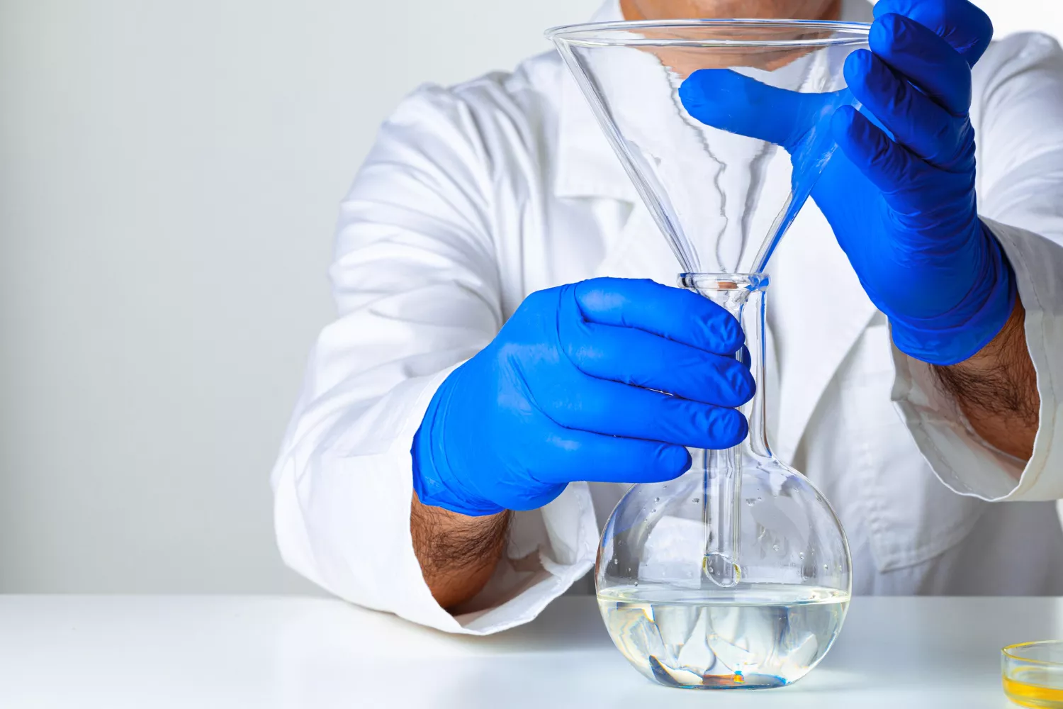 Equinox Labs analyst examining a sample under a microscope